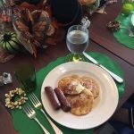 pancakes-and-sausage-laid-out-on-a-table