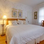 wood floors and queen size bed in the Victorian room