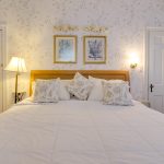 Queen size bed in the Victorian room at the beach walk on the ocean hotel in OCMD