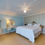 full size bed and flat screen TV in the Oceana room on the boardwalk in OCMD