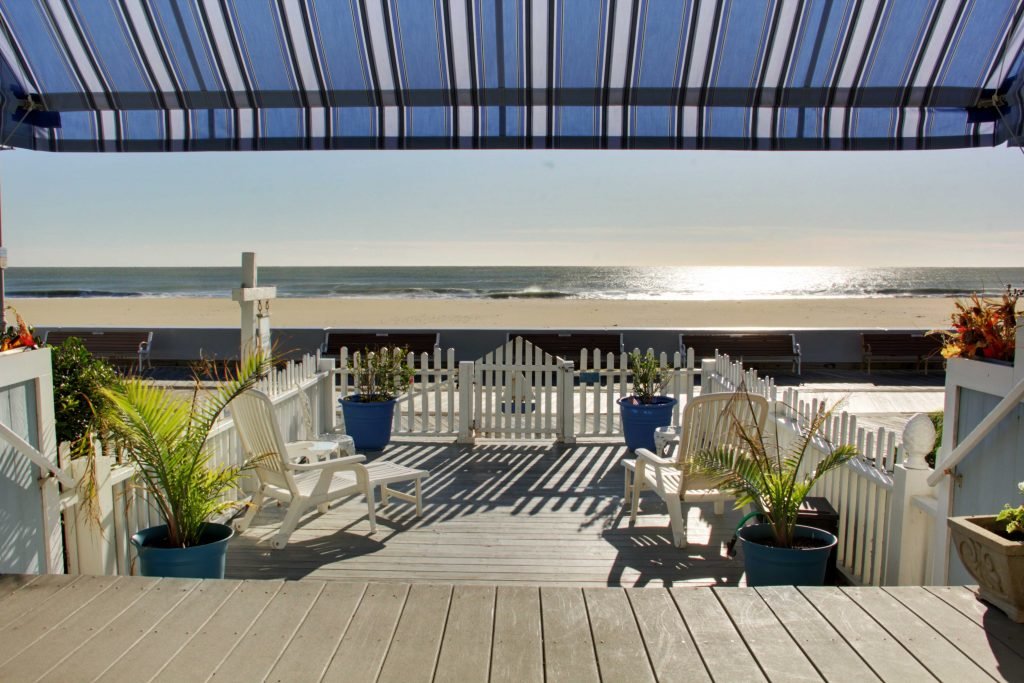 oceanfront view from deck on boardwalk with chairs and plants