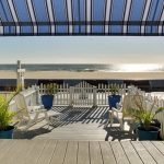 oceanfront view from deck on boardwalk with chairs and plants