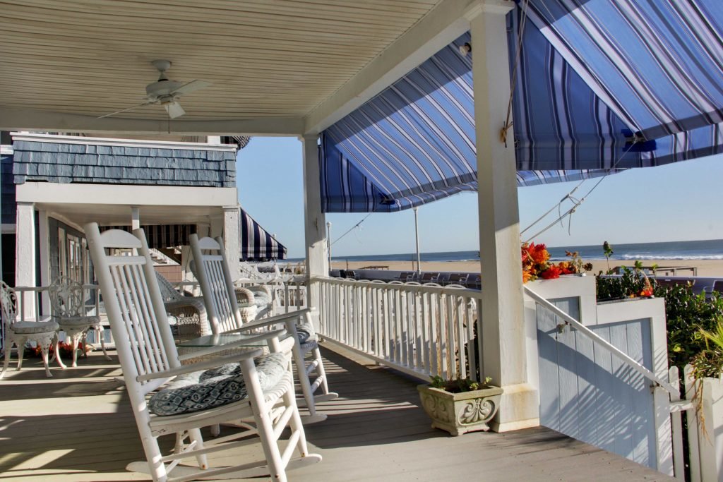 rocking chairs on inn porch with oceanfront view