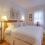 wood floors and queen size bed in the Victorian room at beach walk on the ocean in OCMD